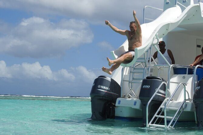 Full-Day Tour Isla Bonita Deluxe - Boarding The Ocean King Deluxe: Solarium, Slide, and Coastline Views