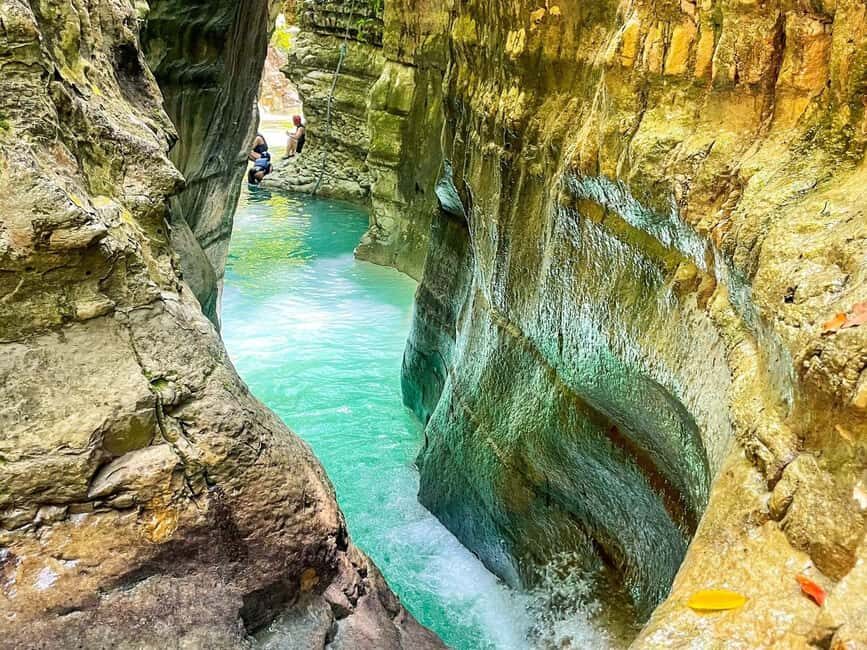 Puerto Plata: Damajagua Waterfalls Canyoning & Cocktail - Entering the Damajagua Canyon: Stream, Rock Slides, and Waterfall Jumps